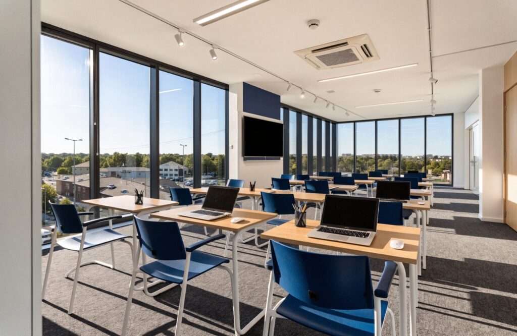 Modern Pacific College Sydney classroom at the Parramatta campus with desks, display screen and floor-to-ceiling windows